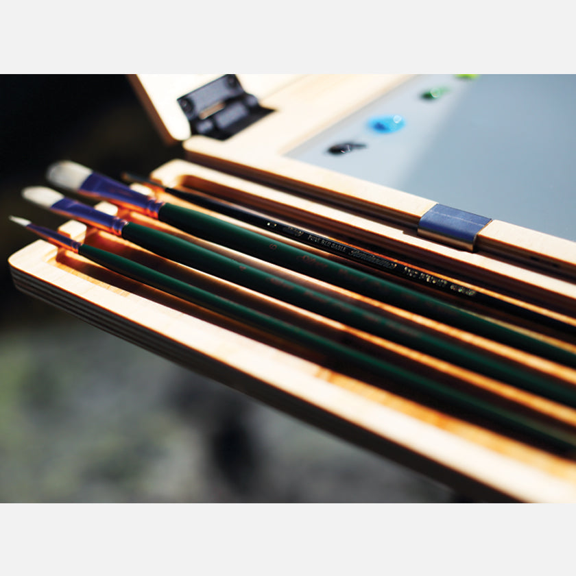 u.go Plein Air Anywhere Side Tray 4" x 11" holding artist brushes