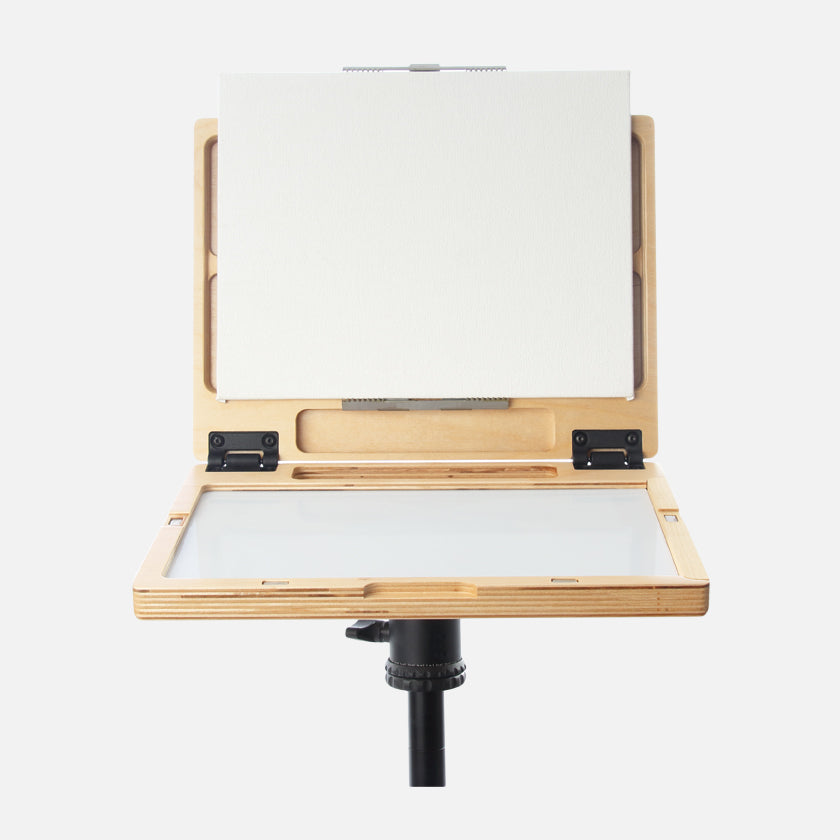 u.go Plein Air Anywhere Pochade Box, 8.4" x 11.25" model, on tripod with canvas panel